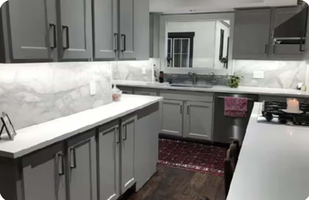 Gray kitchen with warm under-cabinet lighting