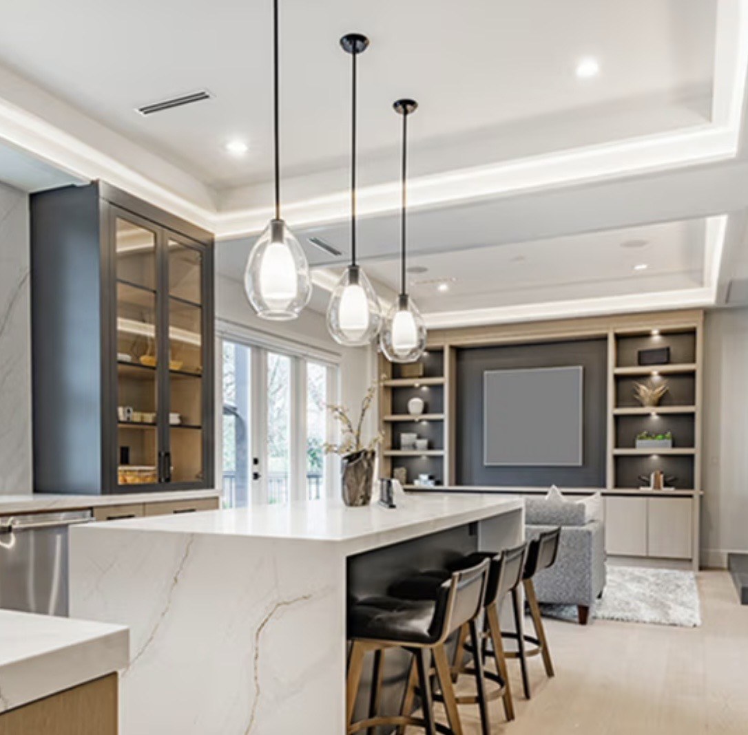Kitchen and living room with tray-ceiling cove lighting