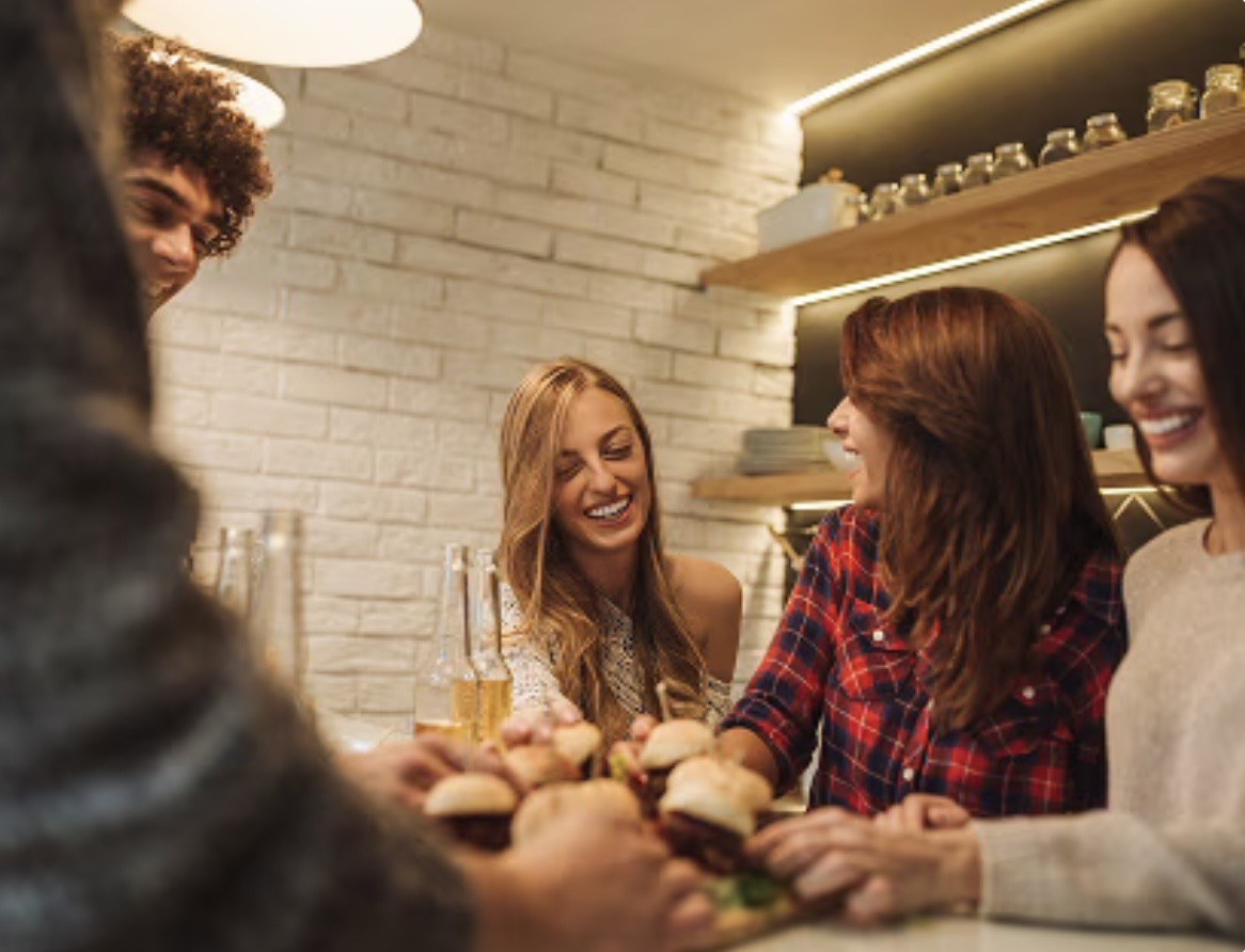 People at a counter under linear shelf lighting
