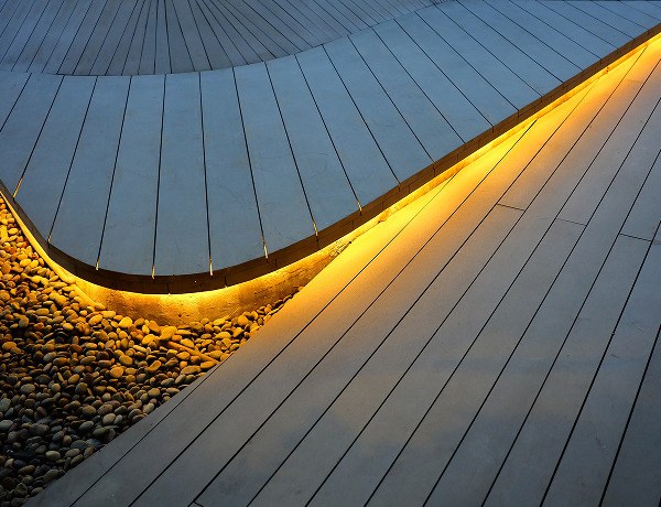 Warm white linear LED along a wooden deck