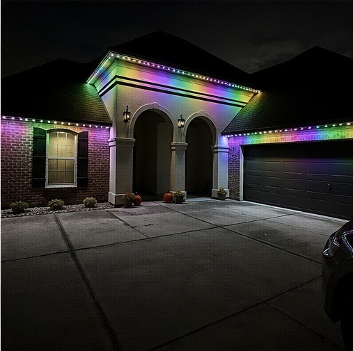 Brick house with rainbow puck lights on a portico