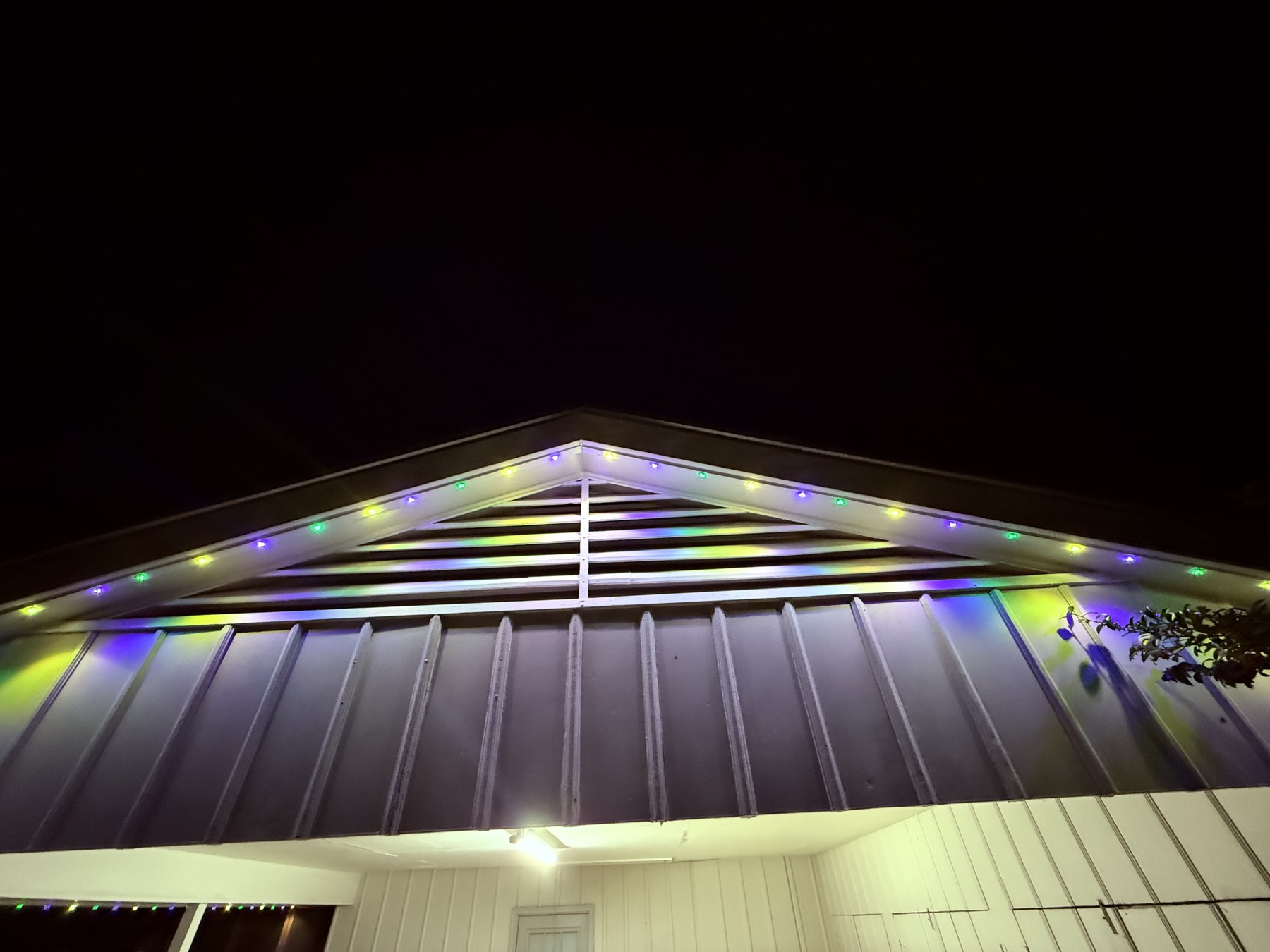 Close-up of multi-color puck lights along a gable eave