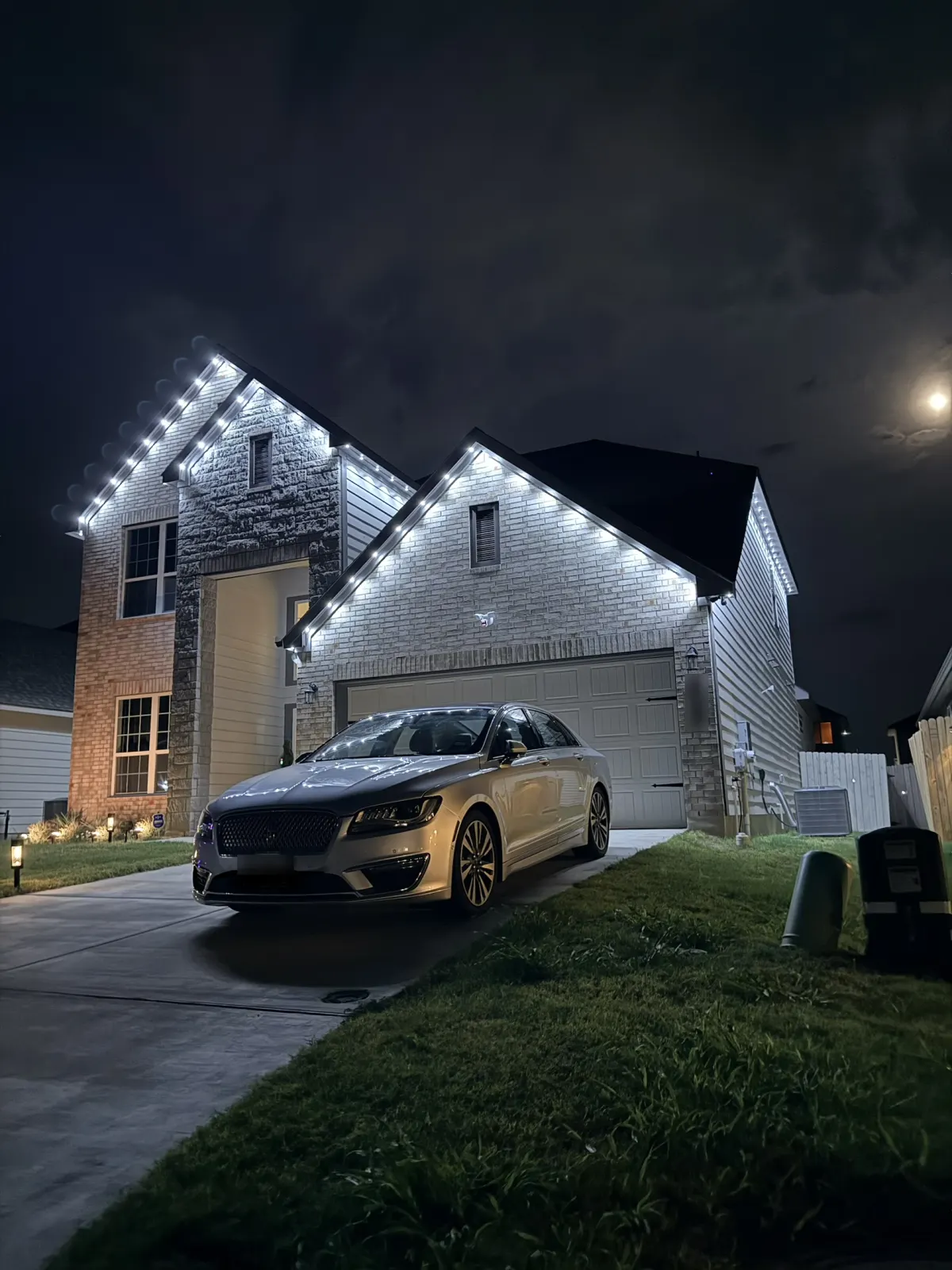 House at night with permanent roofline lights on